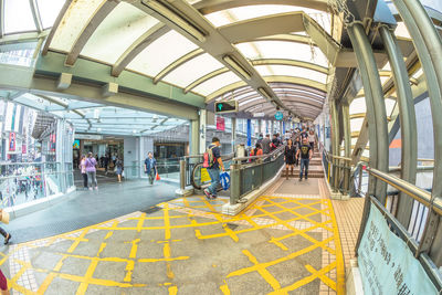 People walking on railroad station platform