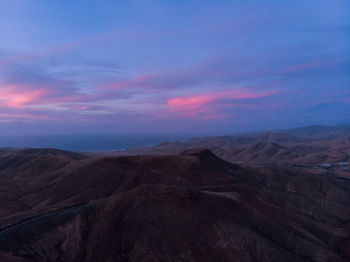 Scenic view of mountains against sky during sunset