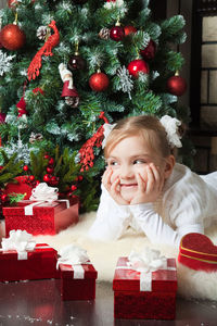 Portrait of smiling girl with christmas tree
