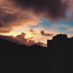 Silhouette of built structure at sunset