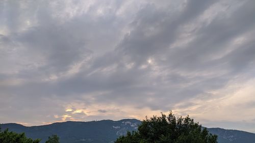 Scenic view of mountains against sky at sunset