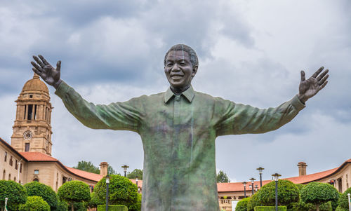 Low angle view of statue against buildings