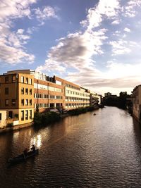 View of river in city against sky