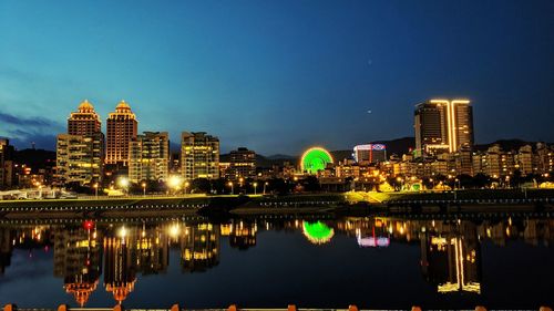 Reflection of illuminated buildings in river at night