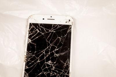 High angle view of broken glass on wall