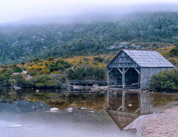 House by lake against building