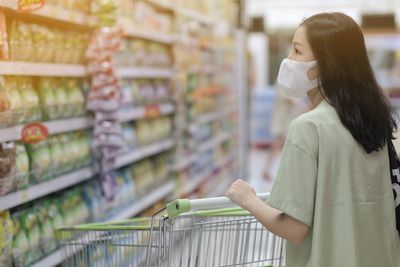 Full length of woman standing at store