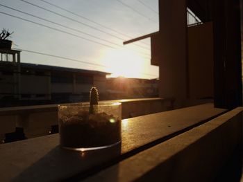 Close-up of water on table against sky during sunset