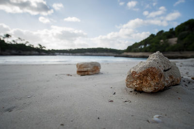 Close-up of sand on beach against sky