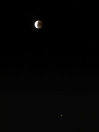 Low angle view of moon against sky at night