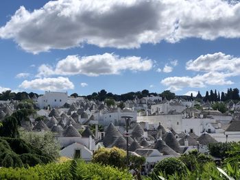 Buildings in city against cloudy sky