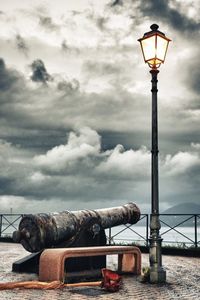 Street light against cloudy sky