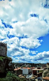 High angle shot of townscape against cloudy sky