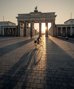 People riding bicycle on street in city