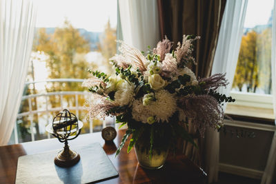 Close-up of flower vase on table at home