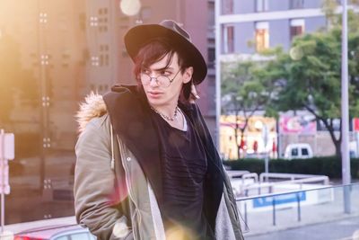 Young woman looking away in city