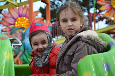 Sisters riding in amusement park ride