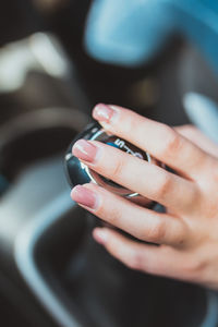 Close-up of woman hand on car gearshift