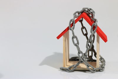 Close-up of padlock on table against white background