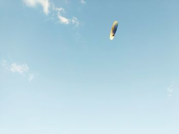 Low angle view of paragliding against sky