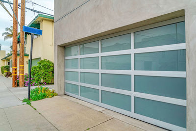 Potted plants by window of building