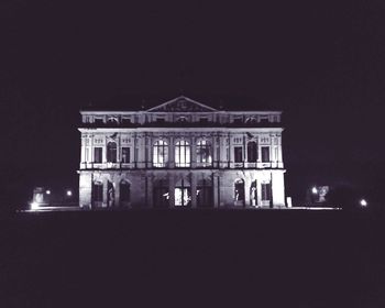 Low angle view of building against clear sky at night