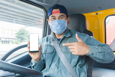 Portrait of man sitting in car