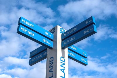 Low angle view of road sign against sky