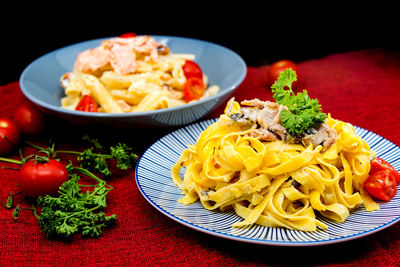 Close-up of pasta on table against black background