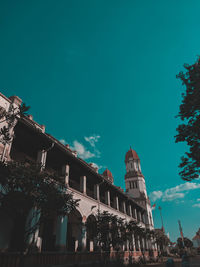 Low angle view of buildings against blue sky