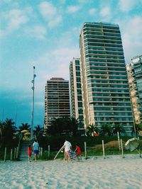 Buildings against cloudy sky