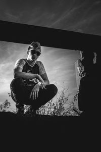 Portrait of man sitting against sky