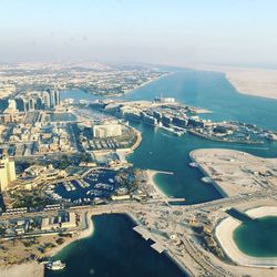 High angle view of sea and buildings in city