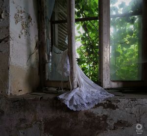 Broken window of abandoned house