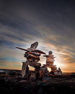 Traditional windmill against sky during sunset