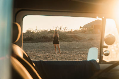Female photographer in the desert taking photos at golden hour.