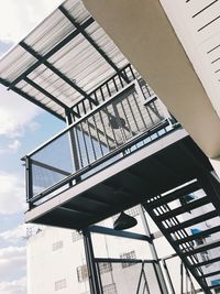 Low angle view of spiral staircase of building against sky