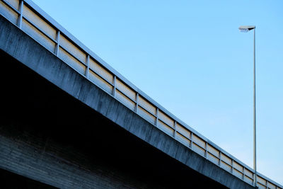 Low angle view of bridge against clear blue sky