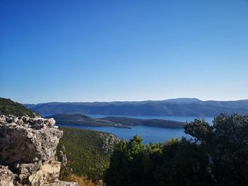 Scenic view of mountains against clear blue sky