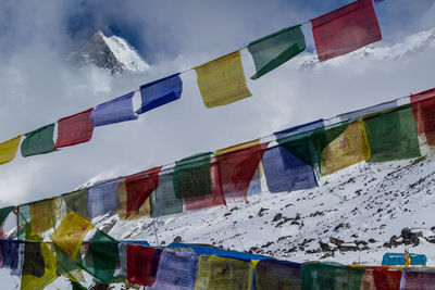 Low angle view of flags hanging against sky