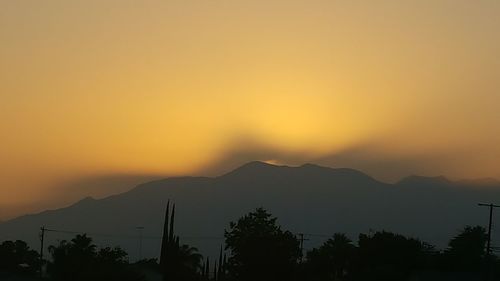 Silhouette of mountain against sky during sunset