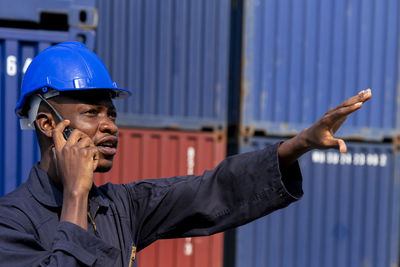 Man working against blue sky