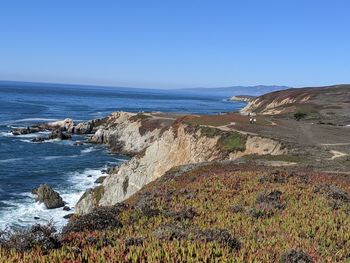 Scenic view of sea against clear blue sky