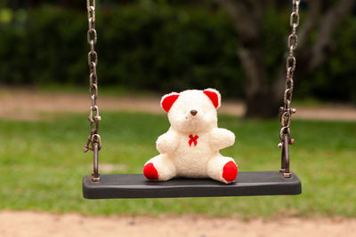 Close-up of toy swing hanging in playground