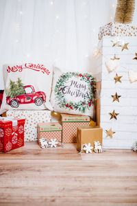 Christmas decoration at home. chimney, gifts, tree, noel, cushions on beautiful indoor white studio.