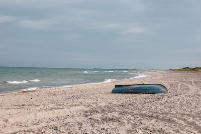 Lifeguard hut on beach against sky