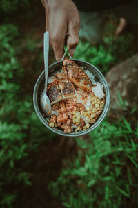 Person holding food in bowl