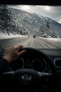 Road seen through car windshield during winter
