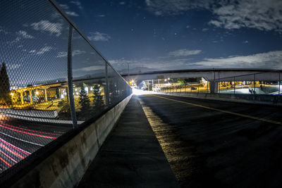 Illuminated bridge in city against sky