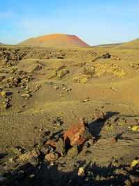 Scenic view of arid landscape against sky